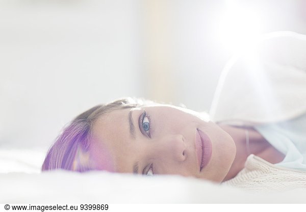 Close up of woman laying on bed