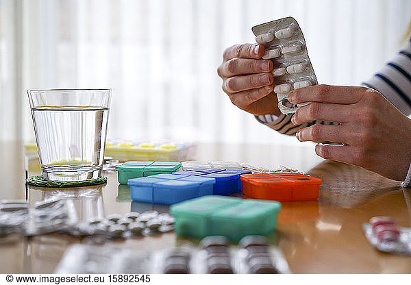 Close-up of woman taking medicine at home