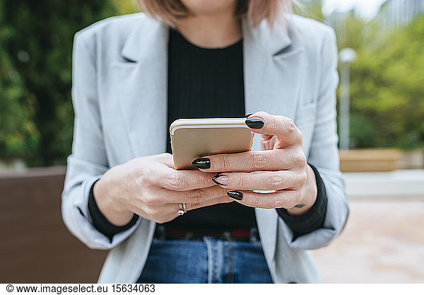Close-up of woman using cell phone outdoors
