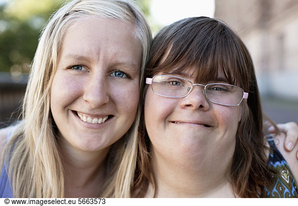 Close-up of woman with down syndrome and personal assistant sharing bonding