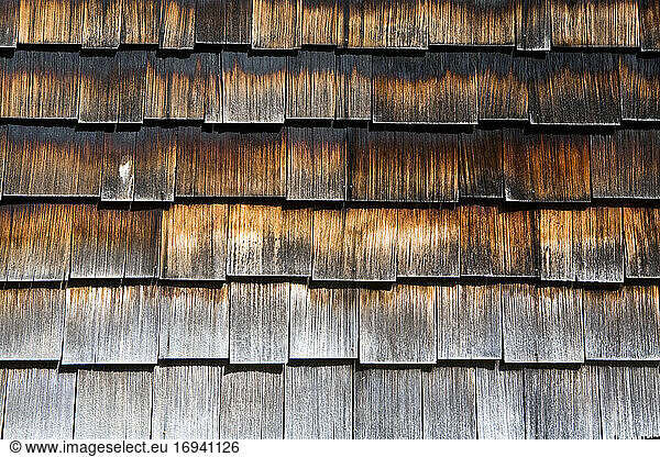 Close up of wooden shingles on the side of a building