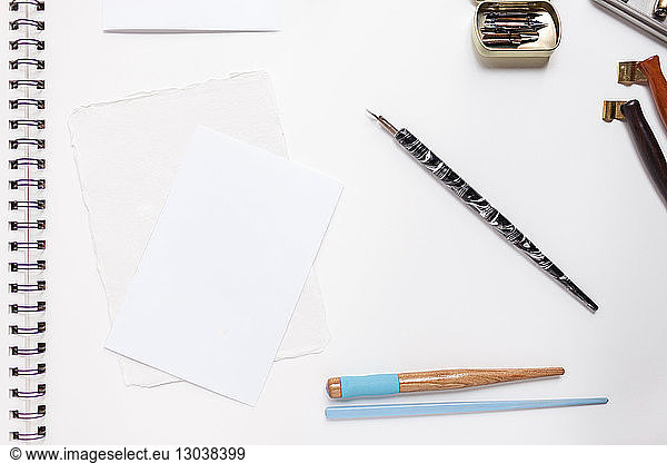 Close-up of writing instruments on spiral notebook