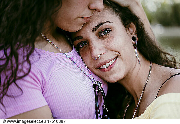 Close-up of young woman embracing girlfriend