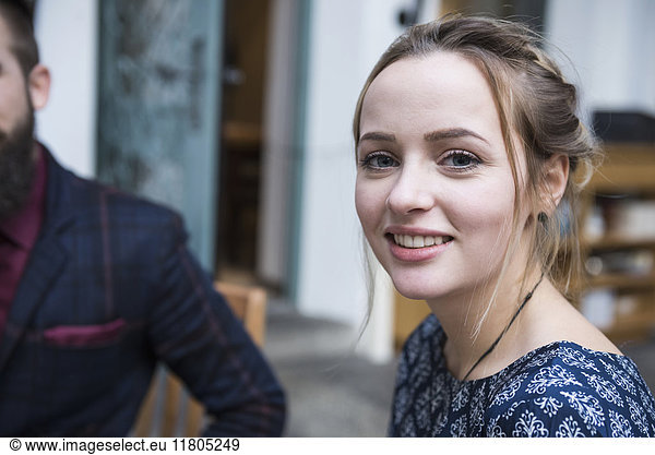 Close-up of young woman smiling at cafe