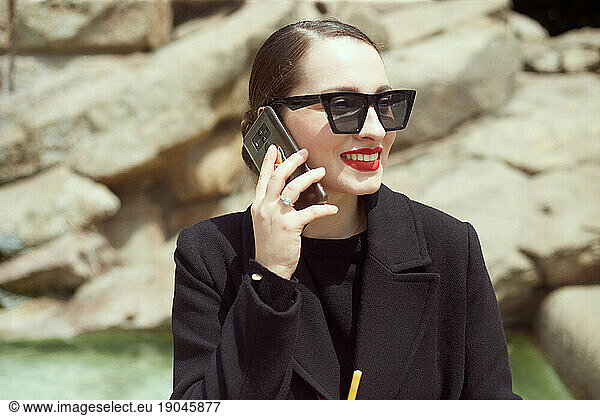 Close up of young woman talking on the phone and smiling