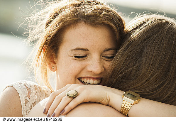 Close-up of young women embracing outdoors