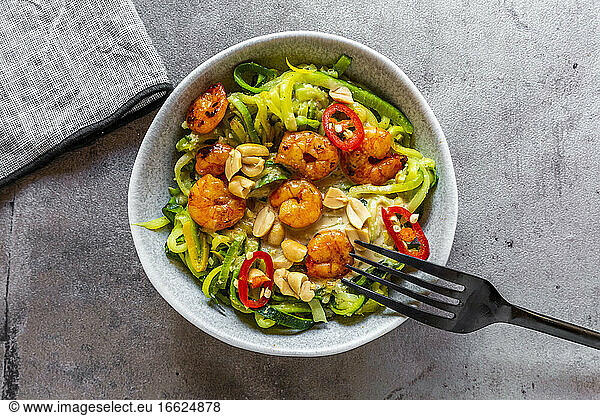 Close-up of zoodles with shrimps and chili served in bowl on table