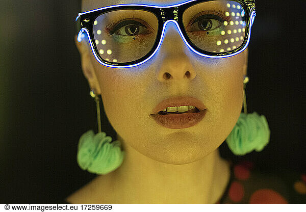 Close up portrait beautiful stylish woman in neon glasses