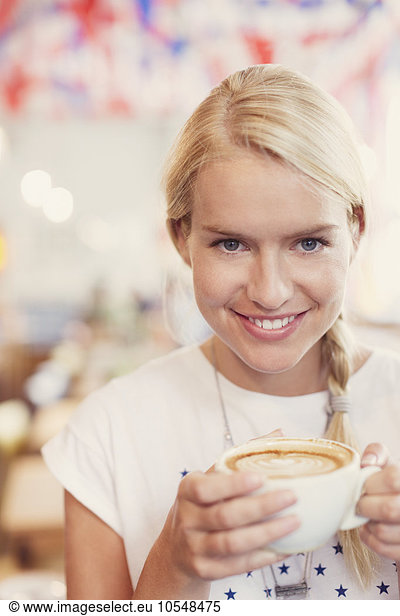 Close up portrait blonde woman drinking cappuccino