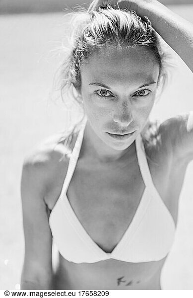 Close up portrait in black and white of a beautiful woman in a bikini