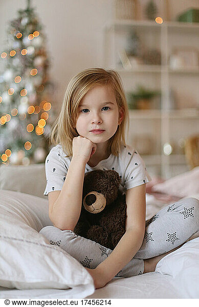 Close-up portrait of a girl with a teddy bear.