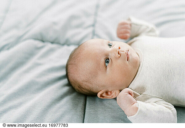 Close up portrait of a newborn baby looking at the ceiling