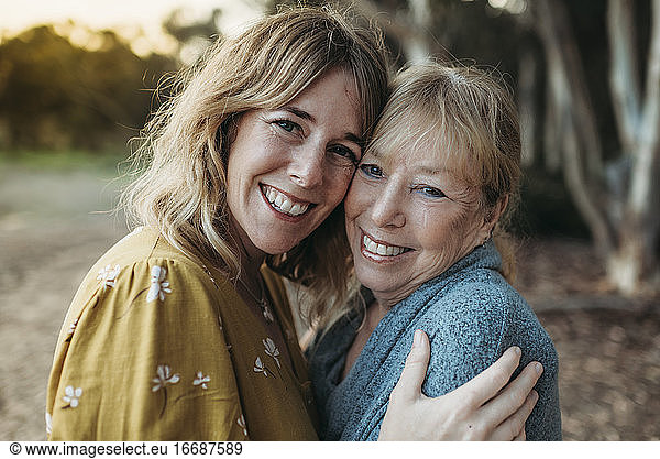 Close up portrait of adult mother and senior mother smiling outside