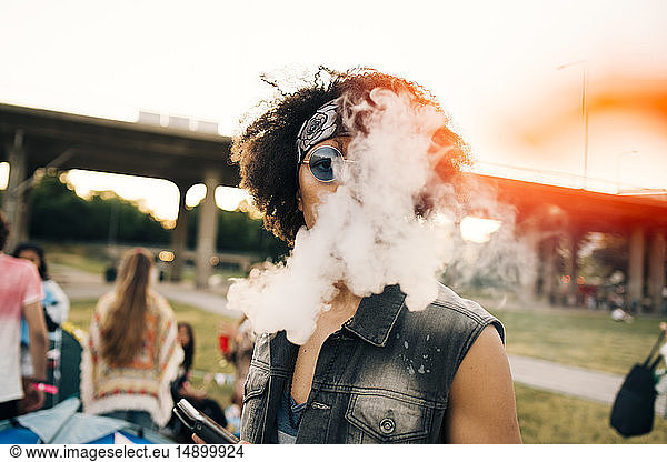 Close-up portrait of man smoking at music festival