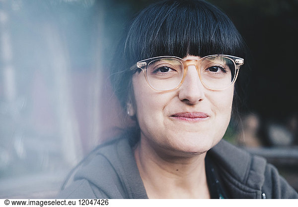 Close-up portrait of smiling woman wearing eyeglasses