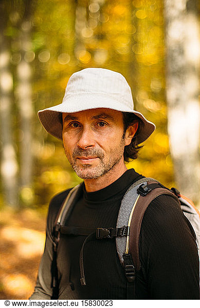 Close-up portrait of tourist man in panama hat. Colorful bokeh