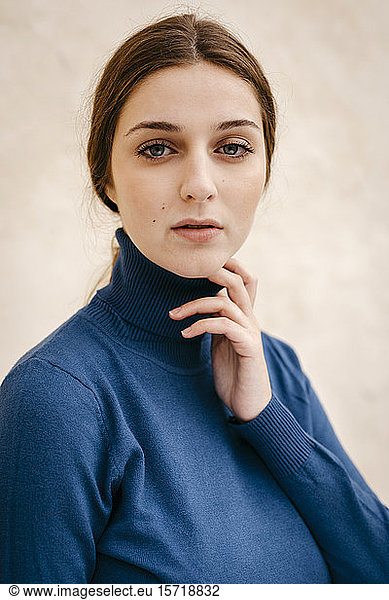 Close up portrait of woman with blue turtleneck pullover