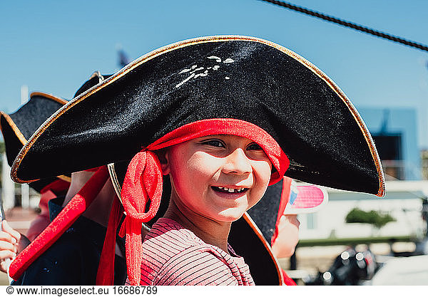 Close up portrait of 6 year multi racial boy in black pirate hat