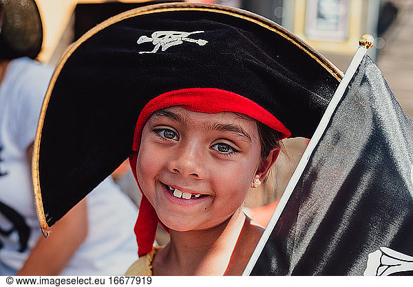 Close up portrait of 8 year multi racial girl in black pirate hat