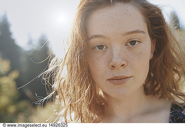 Close up portrait serious young woman with freckles