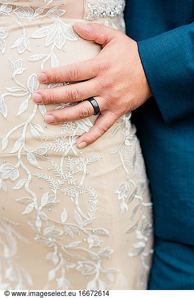 Close up shot of a man wearing his wedding ring at his wedding