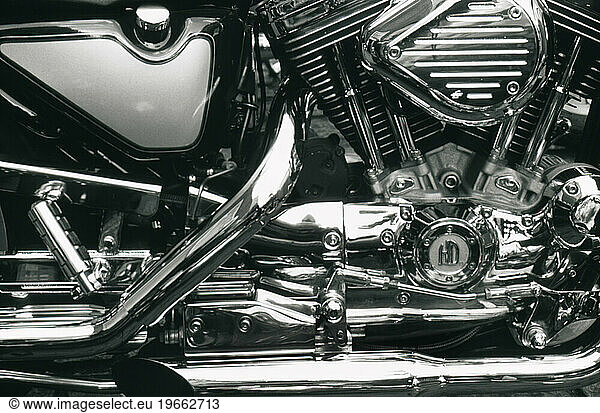 Close up  side view of a motorcycle's chrome engine and parts.