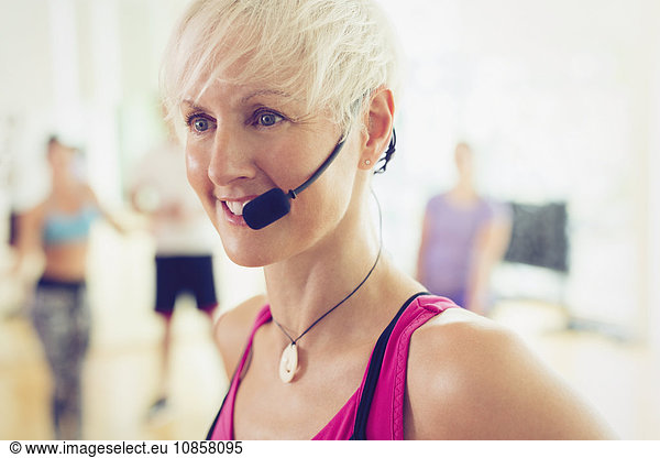 Close up smiling fitness instructor with headset