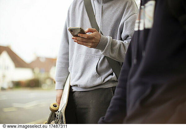 Close up teenage boys using smart phone