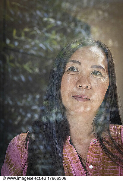 Close up thoughtful woman looking out window