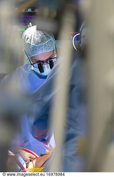 close up view of a heart surgeon wearing his magnifying glasses
