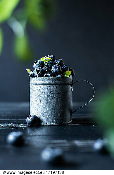 closeup blueberries in vintage metalic cup