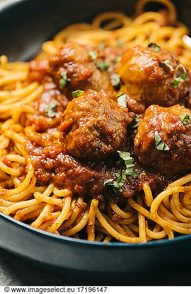 Closeup detail of homemade Italian meatballs in marinara spaghetti