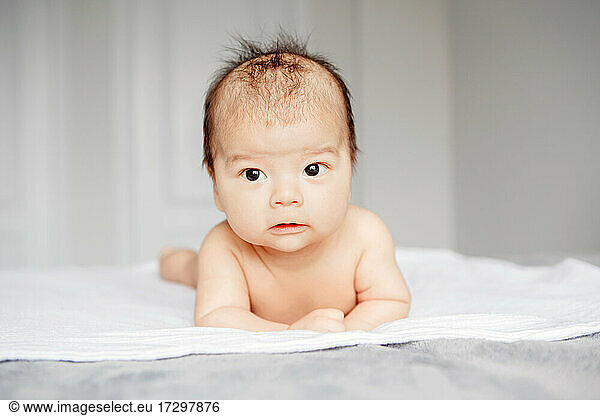 Closeup of adorable aware alert curious Asian Chinese newborn baby