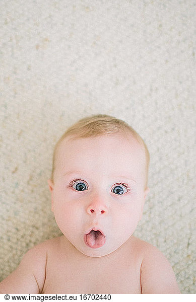 Closeup of baby making funny face at the camera
