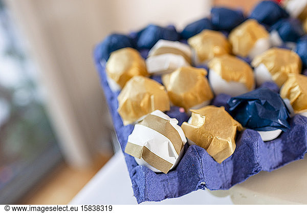 closeup of decorated eggs with gold and white paper