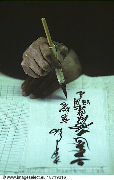 Closeup of Japanese calligrapher's hands and ink pen in Koyasan  Japan.