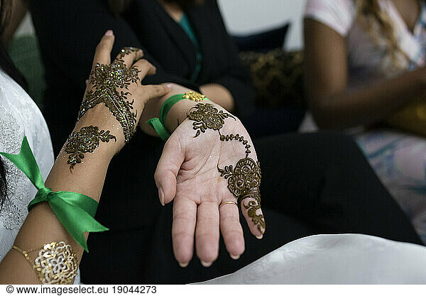 Closeup of moroccan women hands with henna decoration.