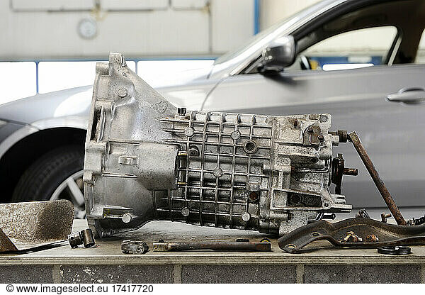 Closeup of motor gear shaft from a car engine at an auto repair shop.