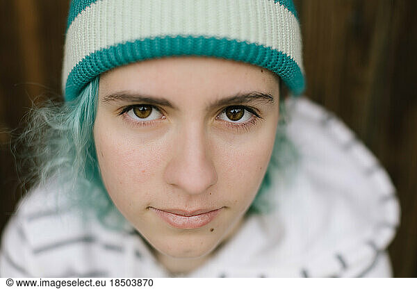 Closeup of teen girl with aqua hair and beanie