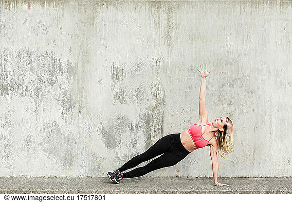 Closeup of woman stretching on concrete stairs