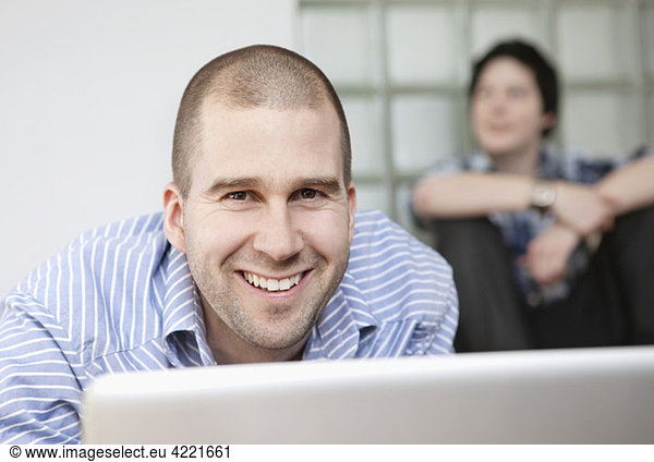Closeup on happy man in front of computer