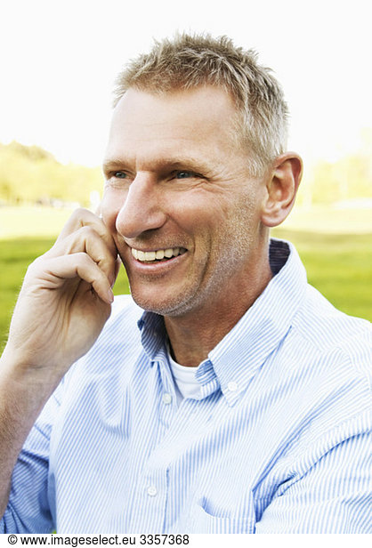 Closeup on happy man talking in cellphone