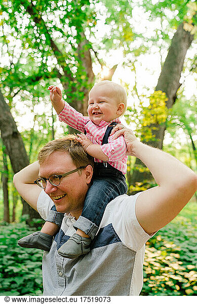 Closeup portrait of a baby boy on his dad's shoulders