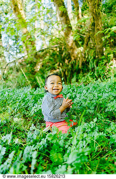 Closeup portrait of a baby boy smiling outdoors at a local park