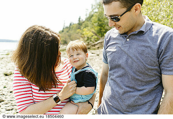 Closeup portrait of a family of three on a sunny summer day