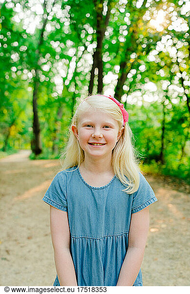 Closeup portrait of a happy young girl on a hiking trail