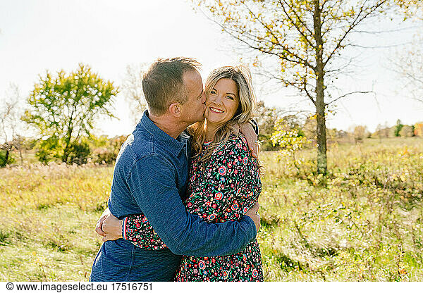 Closeup portrait of a married couple in a grassy field