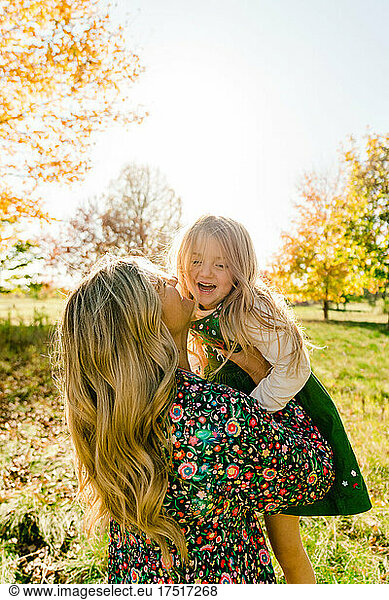 Closeup portrait of a mother lifting her laughing school age daughter