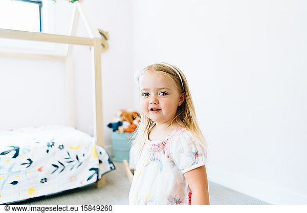 Closeup portrait of a young girl in her modern bedroom