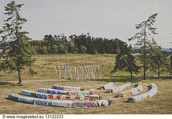 Clothes drying on stones on field against sky
